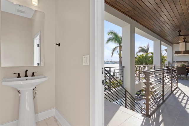 bathroom featuring wooden ceiling, visible vents, and baseboards