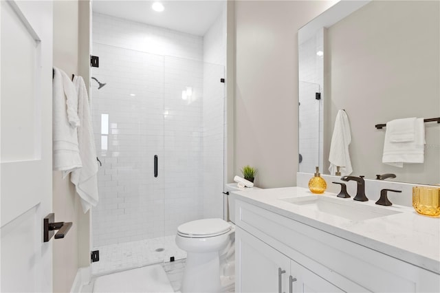 bathroom featuring a stall shower, toilet, marble finish floor, vanity, and recessed lighting