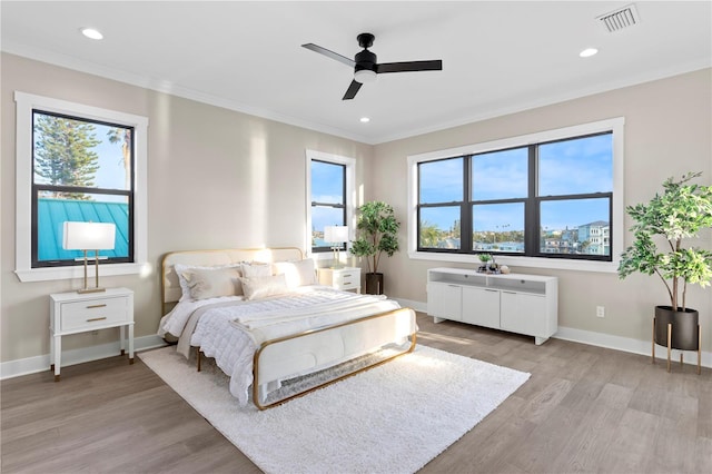 bedroom featuring light wood-style floors, recessed lighting, ornamental molding, and baseboards