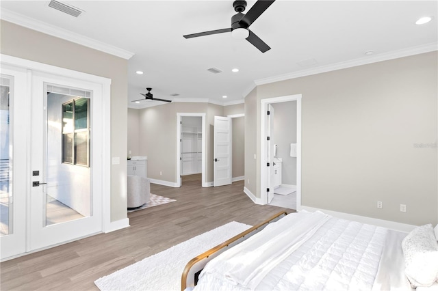 bedroom featuring light wood-type flooring, visible vents, crown molding, and recessed lighting