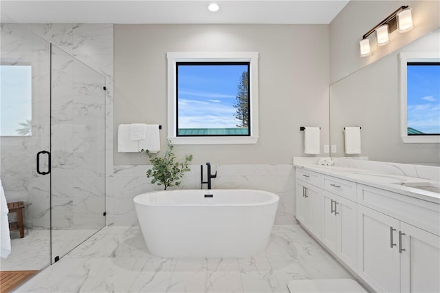 full bathroom featuring marble finish floor, a marble finish shower, recessed lighting, a soaking tub, and vanity