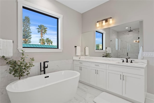 full bath featuring marble finish floor, a marble finish shower, double vanity, a freestanding bath, and a sink