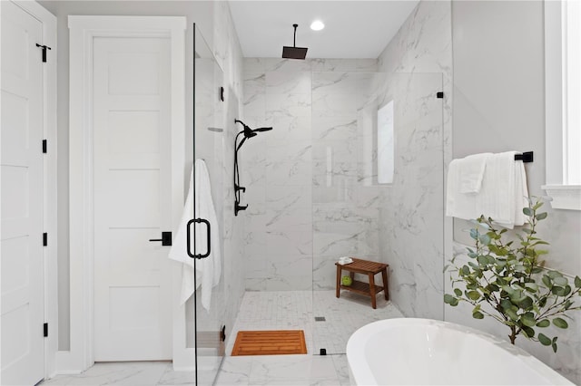 bathroom featuring marble finish floor, a soaking tub, a marble finish shower, and recessed lighting