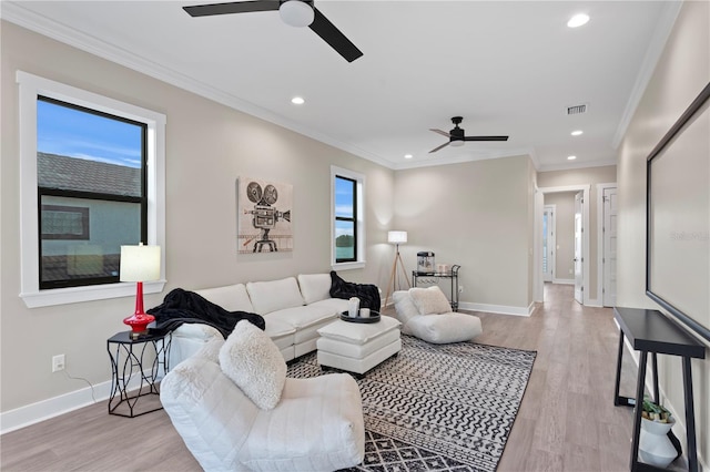 living area featuring crown molding, recessed lighting, visible vents, light wood-style flooring, and baseboards