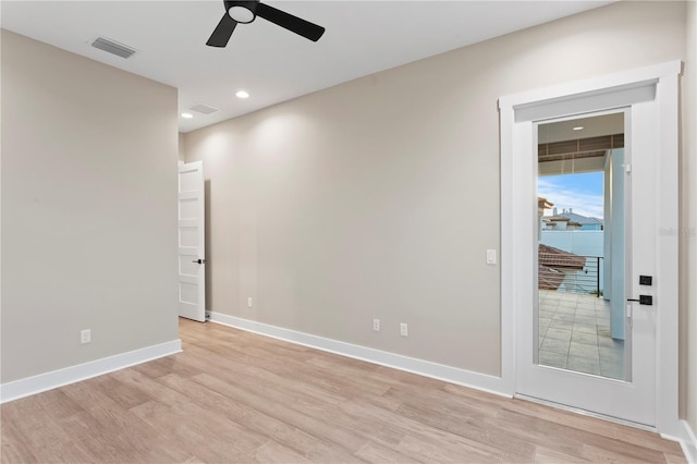 empty room with light wood-style floors, baseboards, visible vents, and recessed lighting