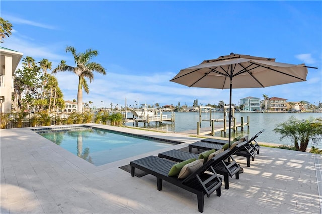 view of swimming pool featuring a water view, a boat dock, and boat lift