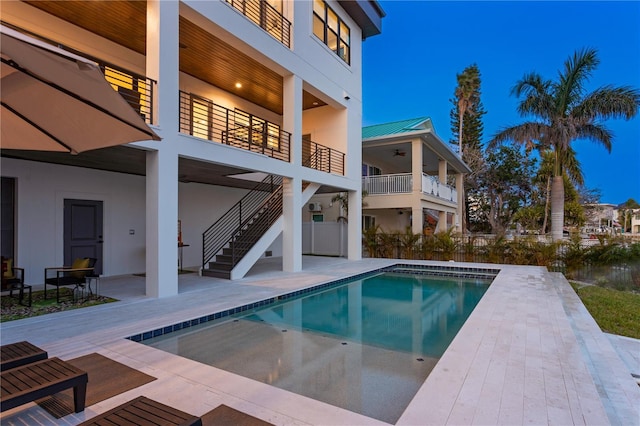 view of pool with a fenced in pool, a patio, ceiling fan, and stairs