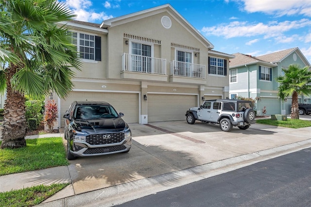 multi unit property with a balcony and a garage