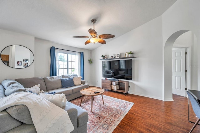 living room featuring a textured ceiling, ceiling fan, dark hardwood / wood-style flooring, and vaulted ceiling