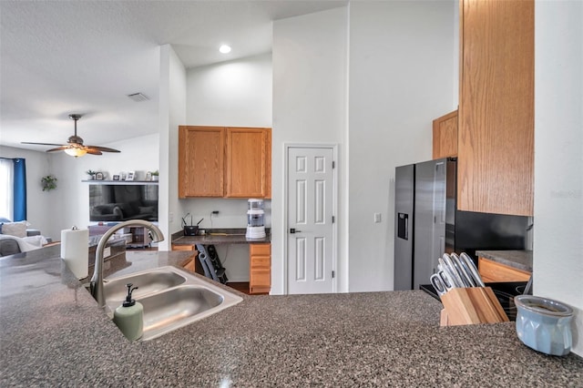 kitchen featuring ceiling fan, kitchen peninsula, and sink