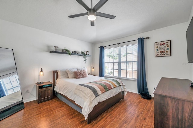 bedroom featuring ceiling fan and dark hardwood / wood-style flooring