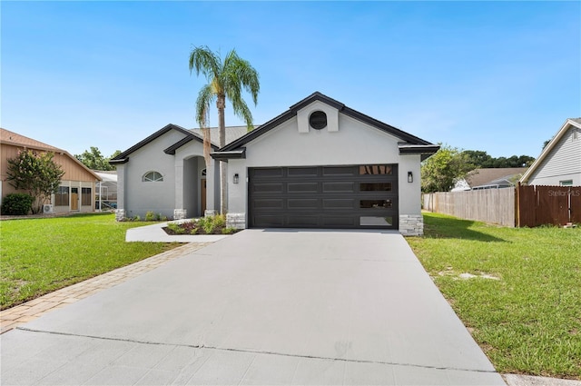 view of front of property featuring a garage and a front lawn