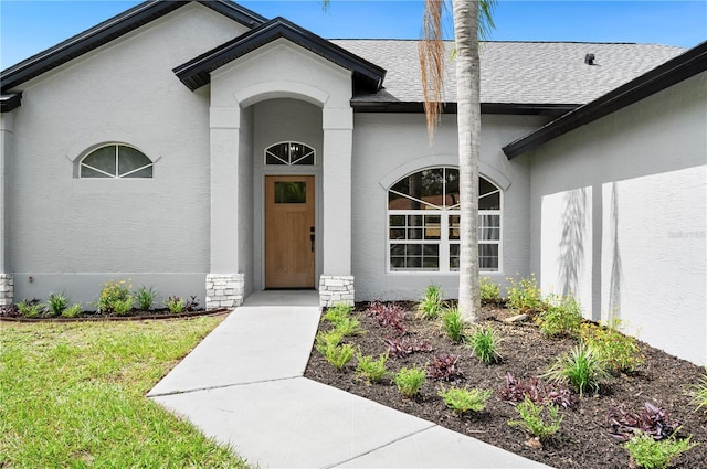 entrance to property featuring a yard