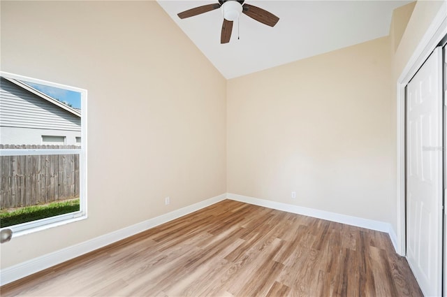 unfurnished bedroom with a closet, light hardwood / wood-style floors, high vaulted ceiling, and ceiling fan