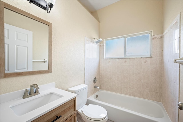 full bathroom with vanity, tiled shower / bath combo, and toilet