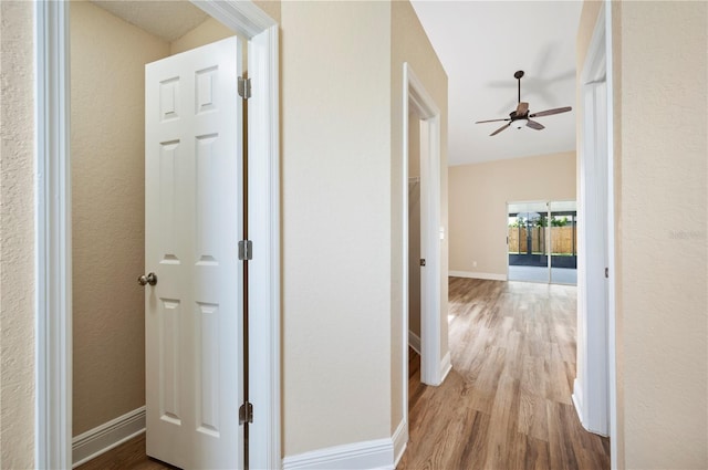 hallway with light hardwood / wood-style floors