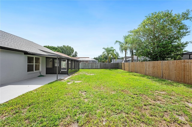 view of yard with a patio area and a sunroom