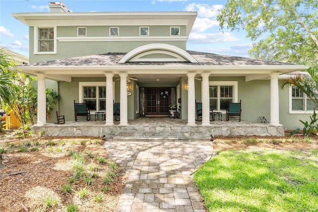 back of property with covered porch