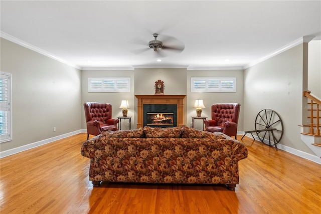 living room with ornamental molding, plenty of natural light, and light hardwood / wood-style flooring