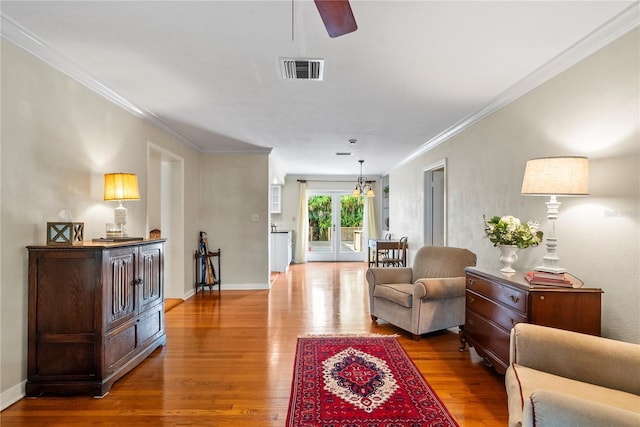 living room with crown molding, french doors, ceiling fan, and hardwood / wood-style flooring