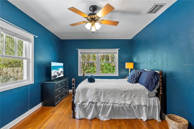 bedroom with light hardwood / wood-style flooring and ceiling fan