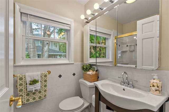 bathroom featuring sink, a shower with shower door, and toilet