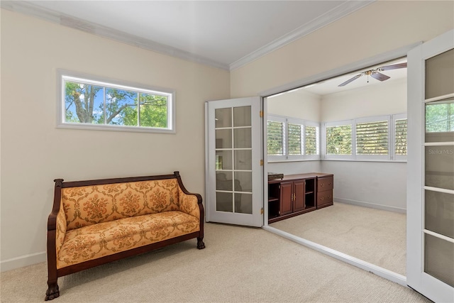 living area featuring french doors, ornamental molding, carpet flooring, and a wealth of natural light