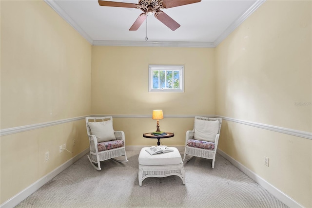 living area featuring crown molding, ceiling fan, and carpet