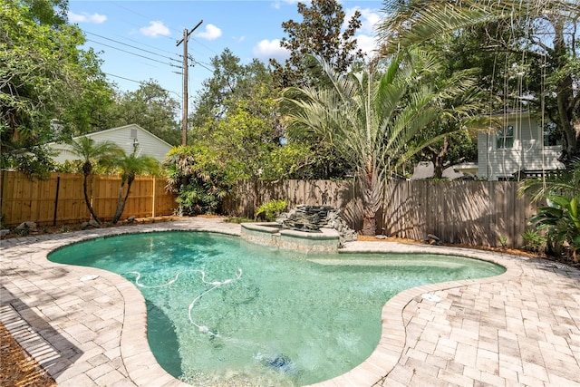 view of pool with a hot tub and a patio area