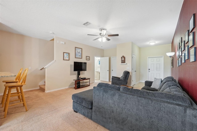 living room featuring ceiling fan and light colored carpet