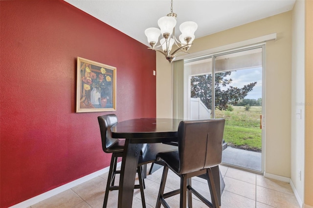 dining room featuring light tile patterned floors and a chandelier