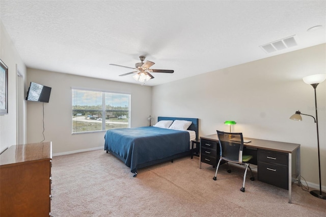 bedroom with ceiling fan and light carpet