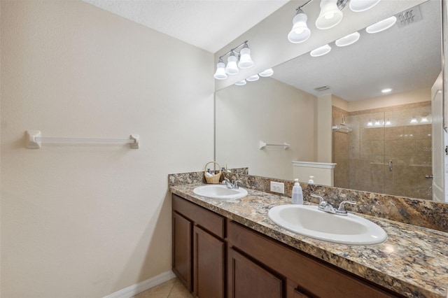 bathroom with tile patterned floors, a shower with shower door, and vanity