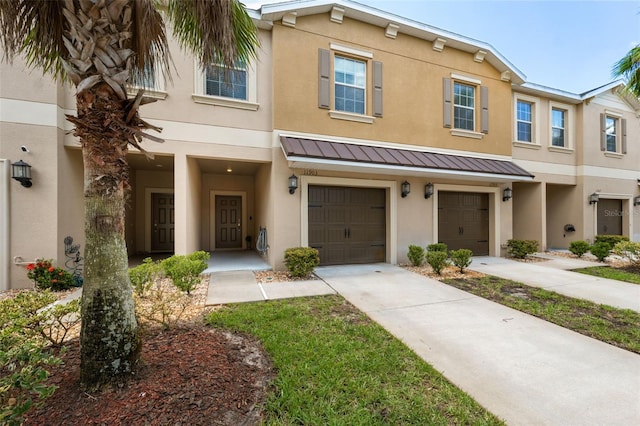 townhome / multi-family property featuring a garage