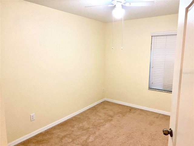 empty room featuring carpet floors and ceiling fan