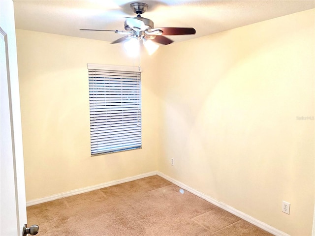 carpeted empty room with ceiling fan