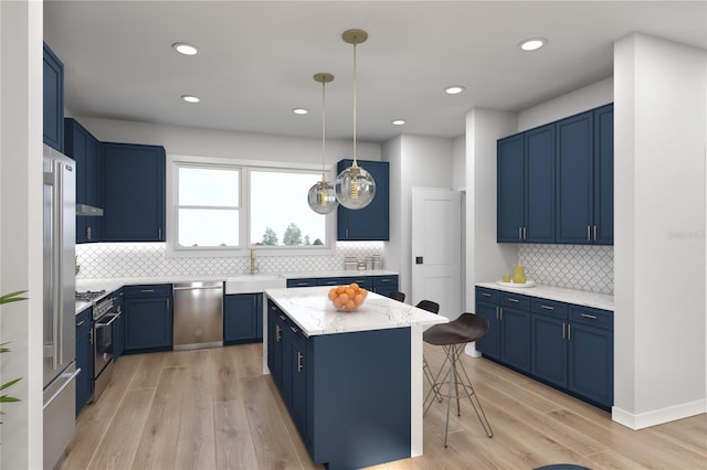 kitchen with a center island, hanging light fixtures, a breakfast bar area, blue cabinetry, and stainless steel appliances