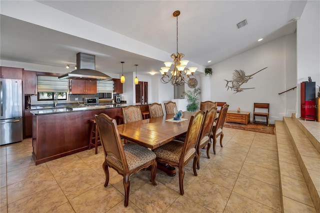 tiled dining area with an inviting chandelier and sink