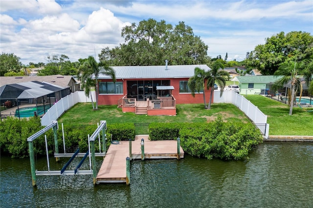 view of dock featuring a yard and a deck with water view