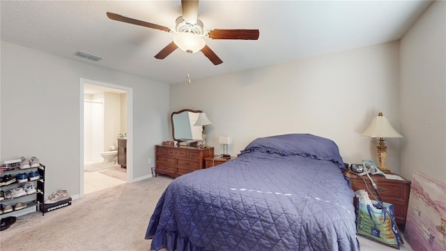 carpeted bedroom featuring connected bathroom and ceiling fan