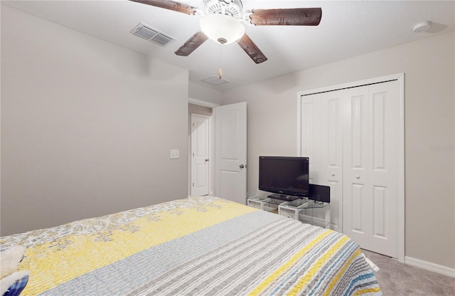 carpeted bedroom with ceiling fan and a closet