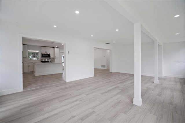 unfurnished living room featuring light hardwood / wood-style floors