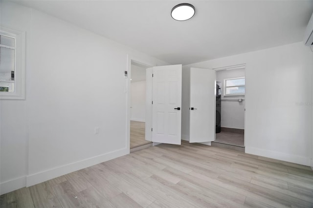 unfurnished bedroom with light hardwood / wood-style flooring and a closet