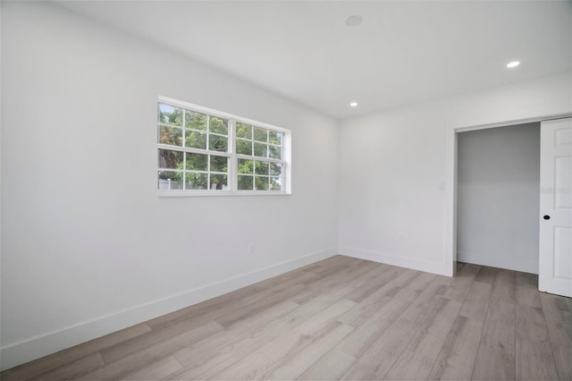 unfurnished bedroom featuring light hardwood / wood-style floors and a closet