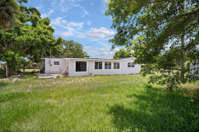 rear view of property with a yard