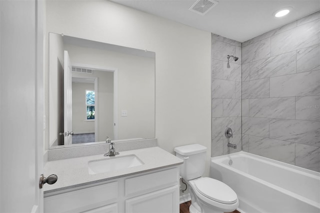 full bathroom with tiled shower / bath combo, toilet, and vanity