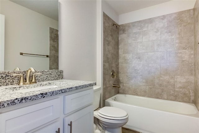 full bathroom with vanity, tiled shower / bath, and toilet