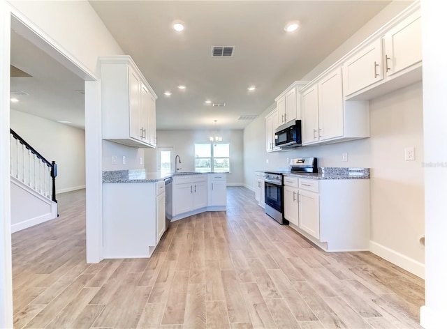 kitchen featuring white cabinetry, light hardwood / wood-style flooring, kitchen peninsula, stainless steel appliances, and light stone countertops