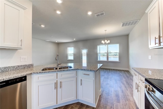 kitchen with white cabinetry, sink, kitchen peninsula, and appliances with stainless steel finishes