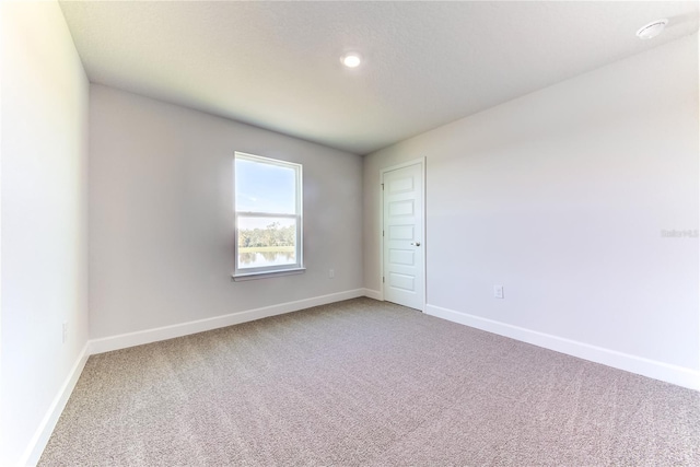 unfurnished room featuring carpet flooring